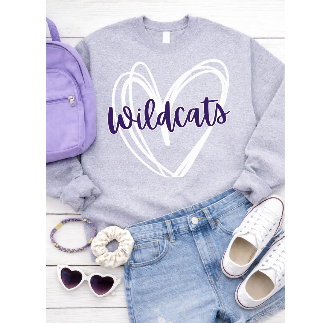 Gray sweatshirt with 'Wildcats' design, purple backpack, denim shorts, white sneakers, scrunchie, sunglasses on a white background.