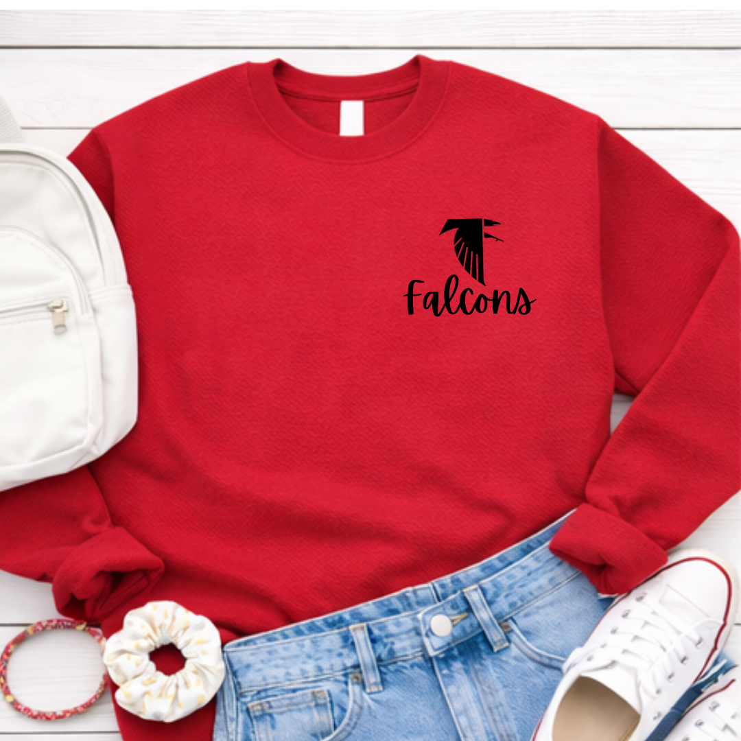Red sweatshirt with 'Falcons' logo on a white surface with accessories. Fireland Falcons School Spirit Crewneck Sweatshirt