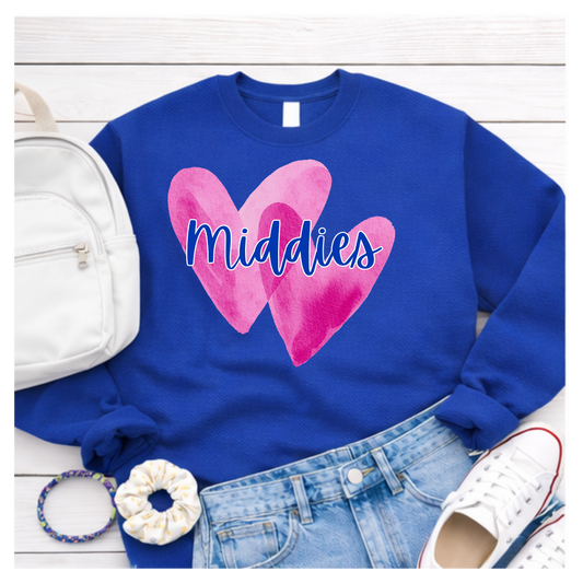Blue sweatshirt with pink hearts and 'Middies' text, displayed with accessories on a white wooden surface.