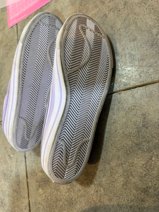 Close-up of a pair of shoes on a concrete floor.