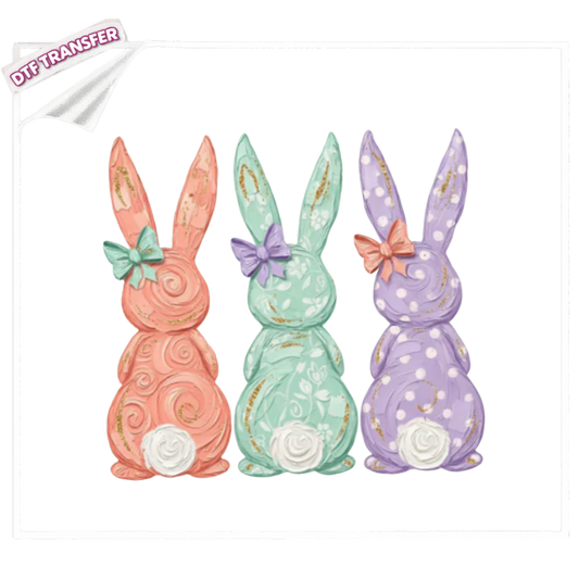 Three decorative bunny figures in pastel colors with floral details on a white background.